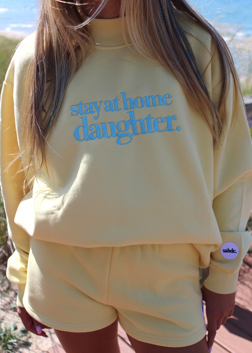 yellow mockneck with stay at home daughter logo 