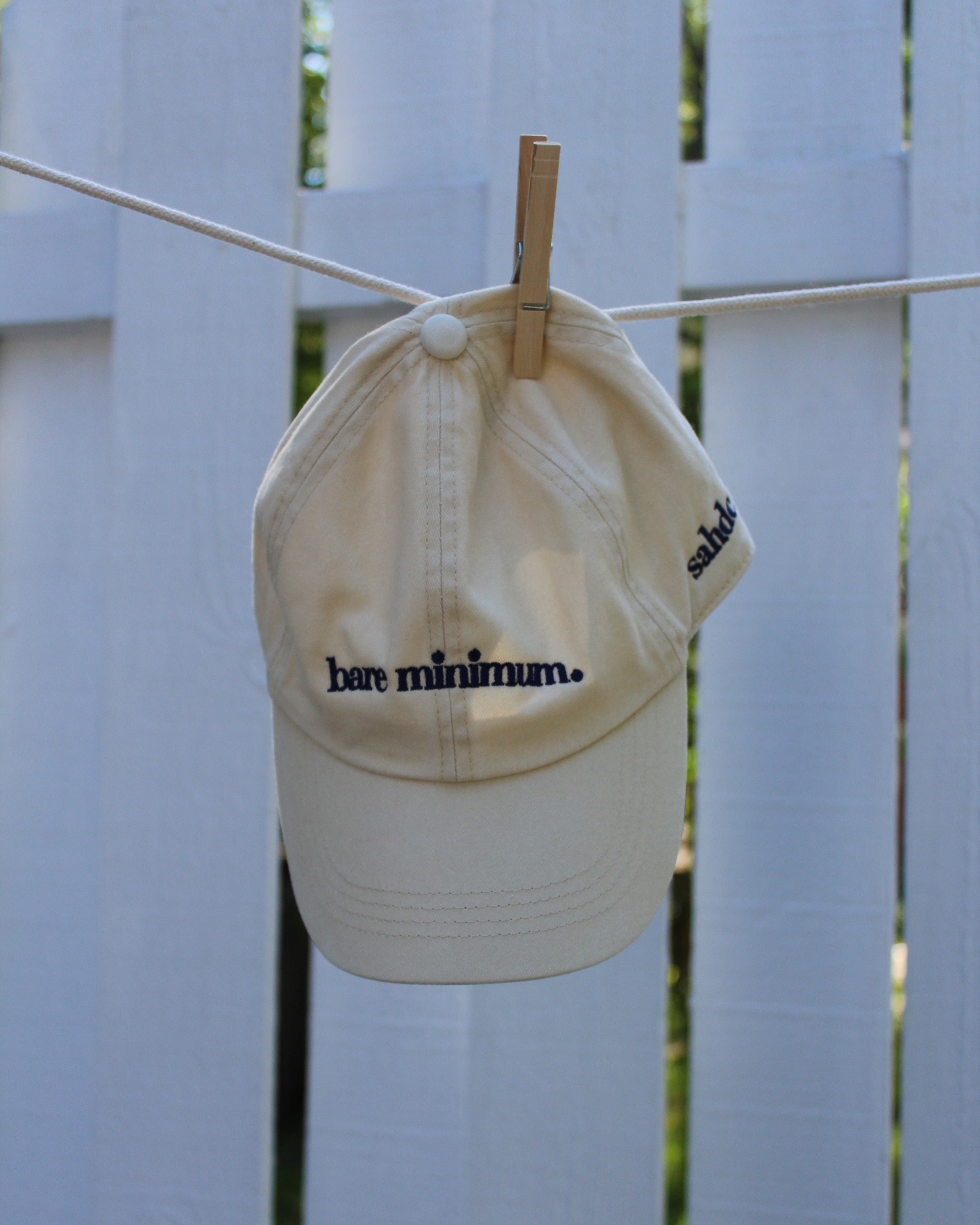 beige cap with text on a white background