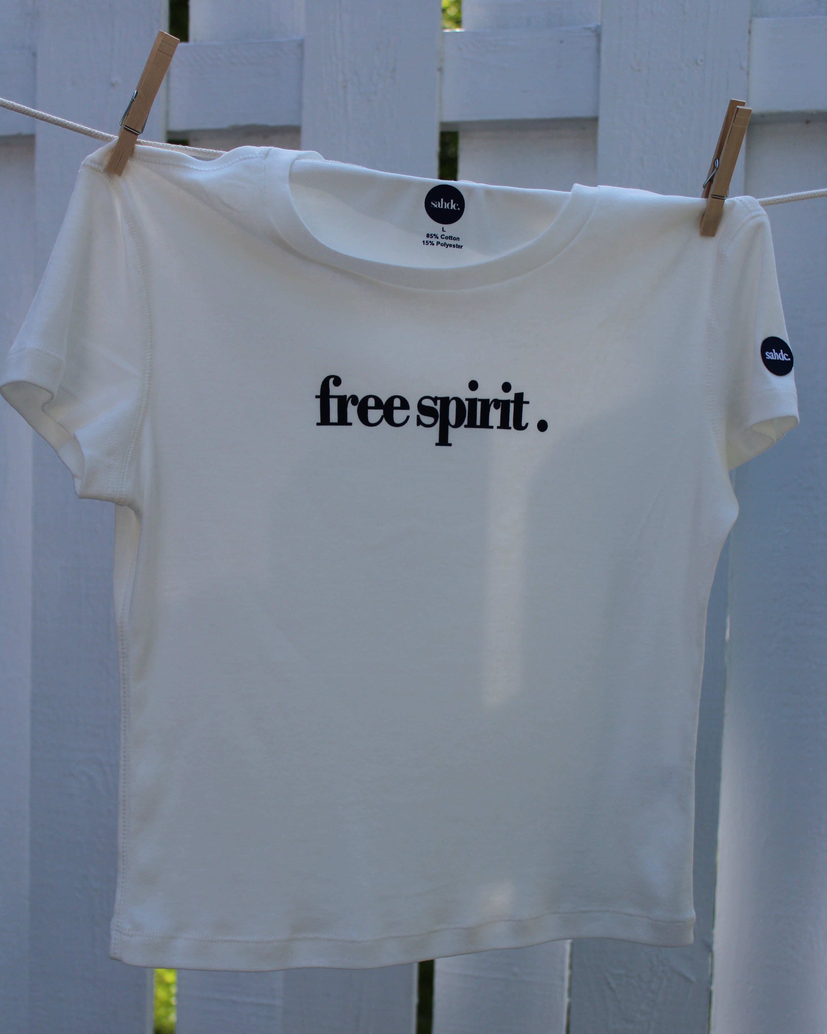 White shirt with 'free spirit.' text on a white background