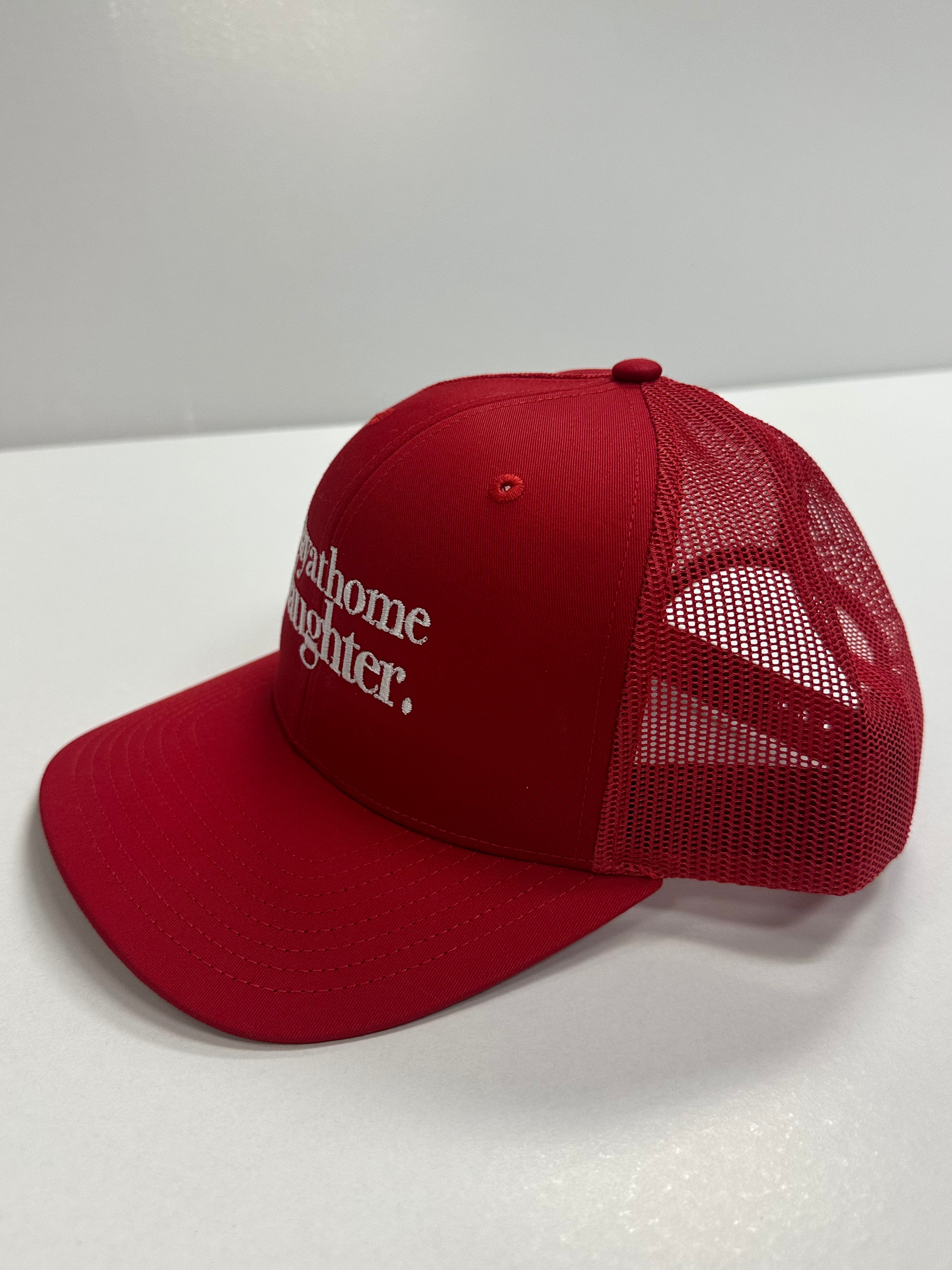 Red cap with mesh back and text on a white surface