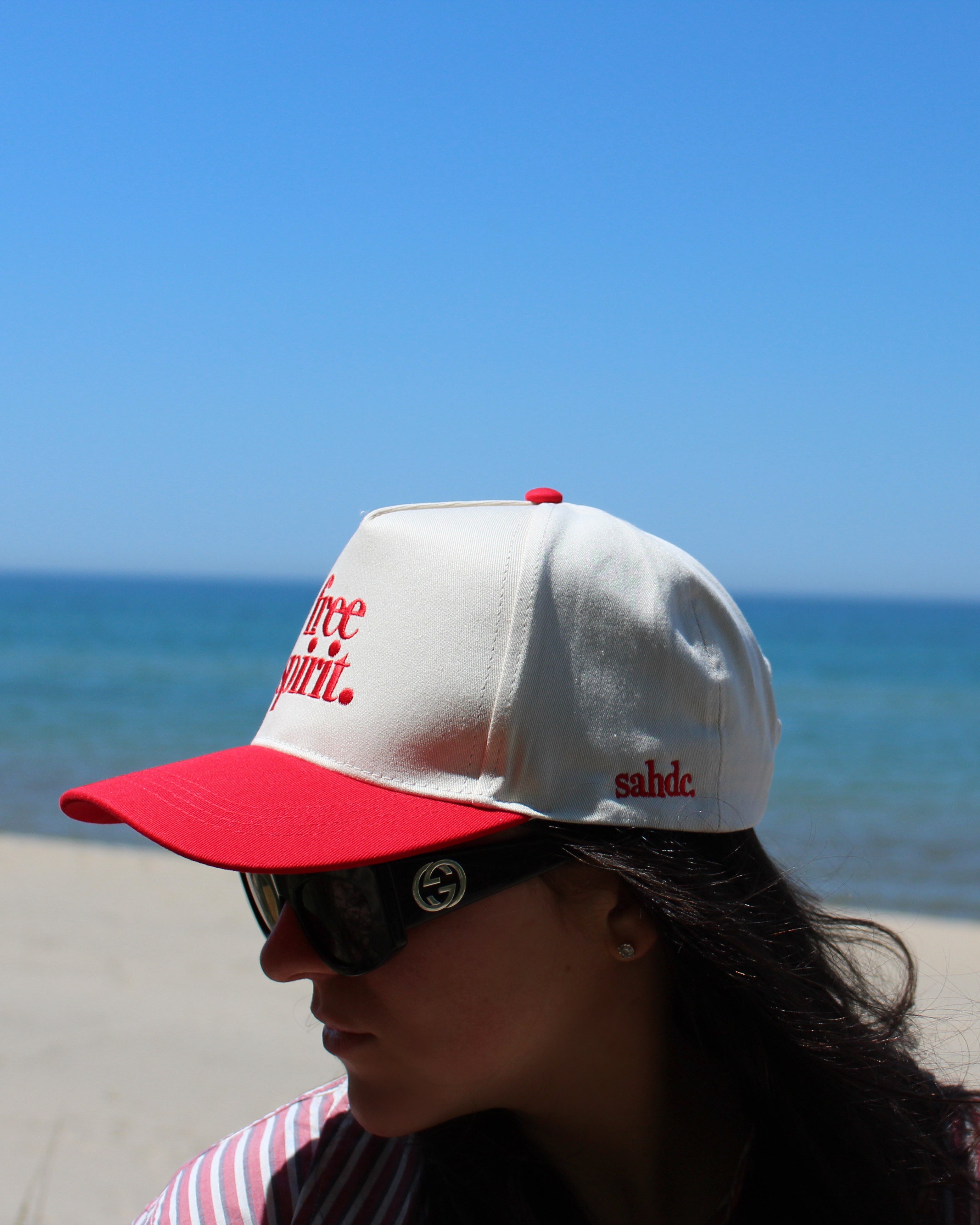 side view of free spirit red hat. sahdc logo 